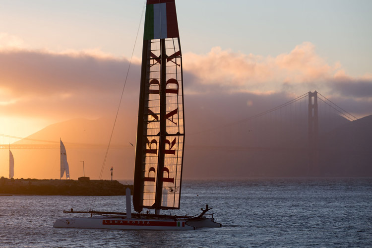 Prada yacths and sunset over Golden Gate.  Image:2013 ACEA/Photo: Gilles Martin-Raget